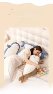 Cute plush seal and narwhal pillows on bed showing soft texture and large size