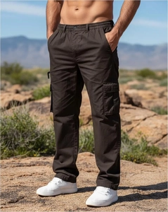 Close-up of deep brown cargo pants with multi-pockets shown in a mountain setting
