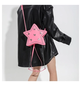 Pink heart-shaped PU leather bag featuring metal studs and decorative butterfly patterns