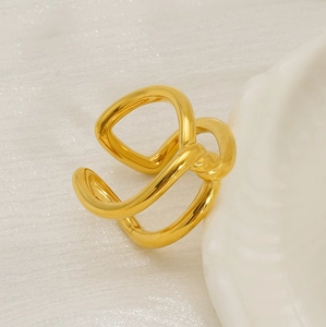 Detail view of 18K gold plated irregular layered ring on textured white fabric