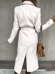Back view of a long beige wool coat with a back slit and matching waist belt detail