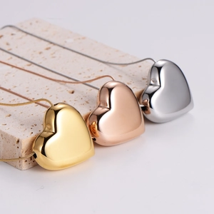 Three-color heart pendant necklaces in gold, rose gold, and silver on snake chains