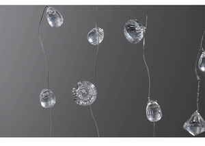 Macro shot of faceted crystal icicle ornaments with transparent acrylic light refraction