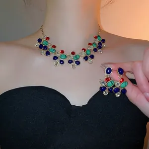 Vintage teardrop jewelry set with colorful gemstones and crystals on gold base