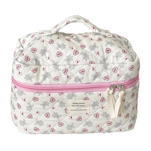 Quilted makeup bag with gray bear and pink heart patterns with a top handle for travel