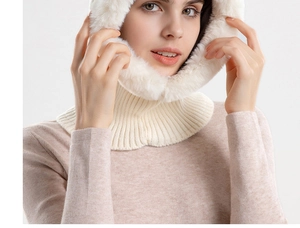 Detail of winter warm faux fur trim on a cream-colored knitted hooded scarf for women