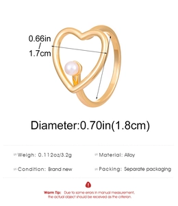 Detailed view of golden heart open ring with white pearl and product size measurements