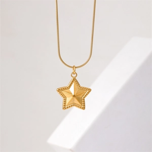 Elegant gold star pendant necklace with snake chain on white geometric stone backdrop