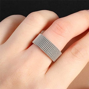 Macro detail of silver woven mesh texture on a titanium steel ring worn on finger