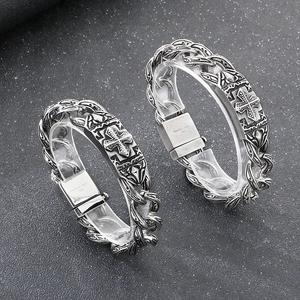 Detail of 316L stainless steel chain bracelets with engraved cross patterns