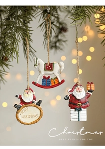 Detail of vintage hand-painted Santa and rocking horse ornaments on a pine branch
