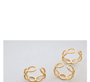 Macro view of three gold interlocking oval link open rings with hollow geometric texture