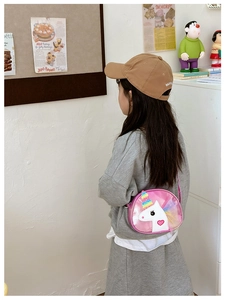 Pink unicorn crossbody bag for girls shown in a stylish lifestyle scene shot