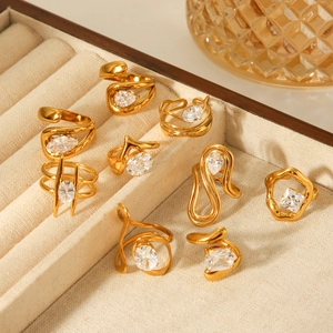 Close-up of gold plated stainless steel zircon rings set on a beige velvet jewelry tray
