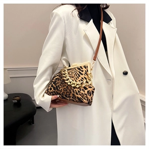 Detail of vintage leopard print shell bag with gold chain and retro clasp closure
