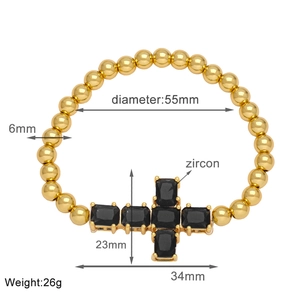 Detail view of 55mm inner diameter gold beaded cross bracelet with black zircon inlay