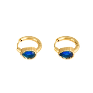 Detail of gold hoop earrings with deep blue pear-cut gemstone drops in vintage style