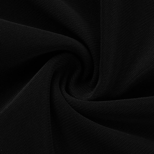 Close-up detail of the black mesh fabric texture with elegant spiral pleated folds