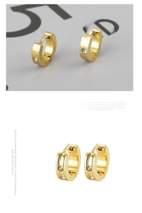 Detailed close-up of gold plated stainless steel huggie earrings with round zircon stones