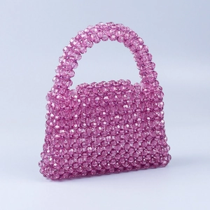 Detail of hand-woven purple acrylic beaded trapezoid handbag with faceted beads