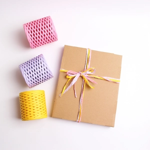Colorful raffia paper ribbons in pink, purple, and yellow for DIY gift packaging