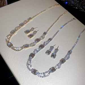 Detail view of square rhinestone pendant necklaces and earrings set in gold and silver