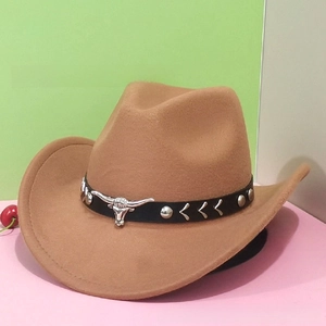Detailed close-up of brown wool felt cowboy hat with silver bull head emblem on black band