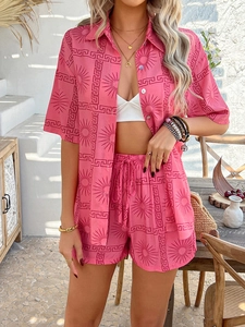 Detail view of pink bohemian print short set with sun patterns and collar buttons