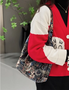 Detail of blue brocade jacquard shoulder bag with traditional Chinese floral patterns
