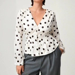 Elegant white polka dot V-neck long sleeve blouse with peplum waist and button closure