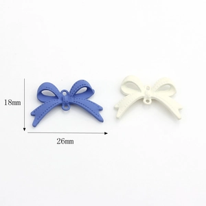 Matte finish alloy bow charm in blue and white colors measuring 26mm by 18mm