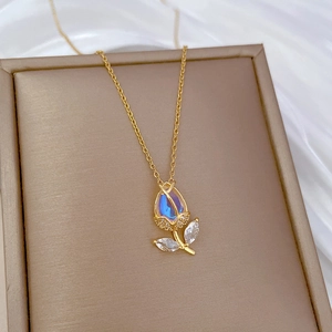 Detail of tulip pendant with blue-purple gemstone and small diamonds on a gold chain