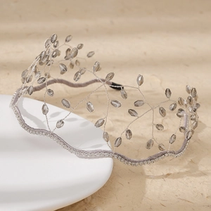 Macro detail of handmade crystal beaded crown headband with silver wire and rhinestones