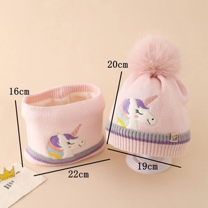 Detailed close-up of pink knit hat and neck warmer set with unicorn embroidery for kids