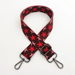 Detail of star pattern wide woven strap with dark gunmetal swivel lobster clasps