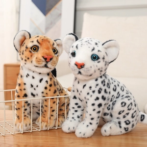Detailed view of plush snow leopard and cheetah dolls with soft fur and vivid glass eyes