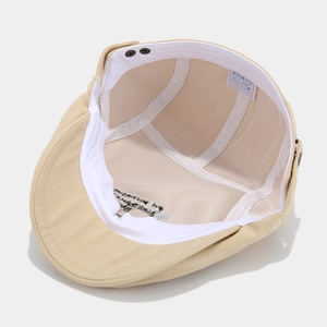 Detail view of cotton flat cap interior featuring embroidery and sweatband details