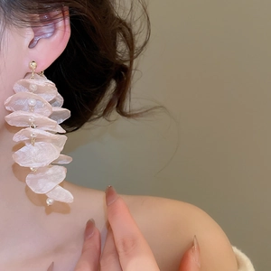 Detailed view of layered chiffon flower petals with white pearls on elegant earrings