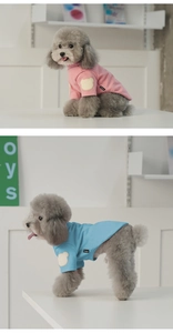Detailed view of pink and blue dog t-shirts featuring cute bear patches and cotton fabric