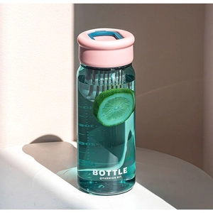Detail of 300ml clear plastic water bottle with pink lid, blue strap and tea infuser