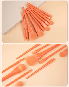 Detail of 10-piece candy orange makeup brush set with dense bristles and glossy handles