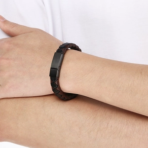 Close-up of men's woven leather bracelet with matte metal magnetic clasp on wrist