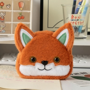 Close-up of orange plush fox coin purse with soft texture and cute embroidered details