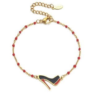Detail of gold stainless steel chain bracelet with red beads and black high heel charm