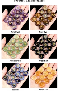 Polished crystals with gold engraved zodiac symbols including Amethyst and Tiger Eye stones