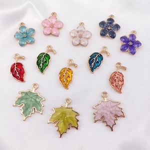 Assorted colorful enamel flower and maple leaf charms for DIY jewelry making