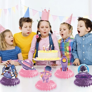 Space-themed birthday party honeycomb centerpieces with astronauts, rockets, and planets