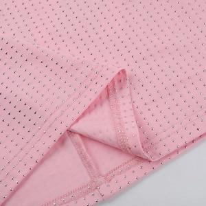 Close-up of pink elegant dress fabric featuring silver rivet studs and fine stitching details