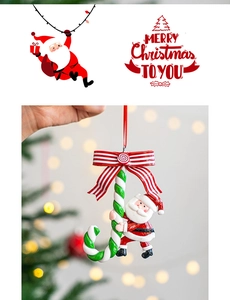 Detail of Santa Claus climbing a red and green candy cane ornament with red ribbon