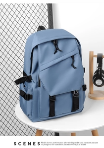 Morandi blue waterproof laptop backpack with multi-pocket design on white table